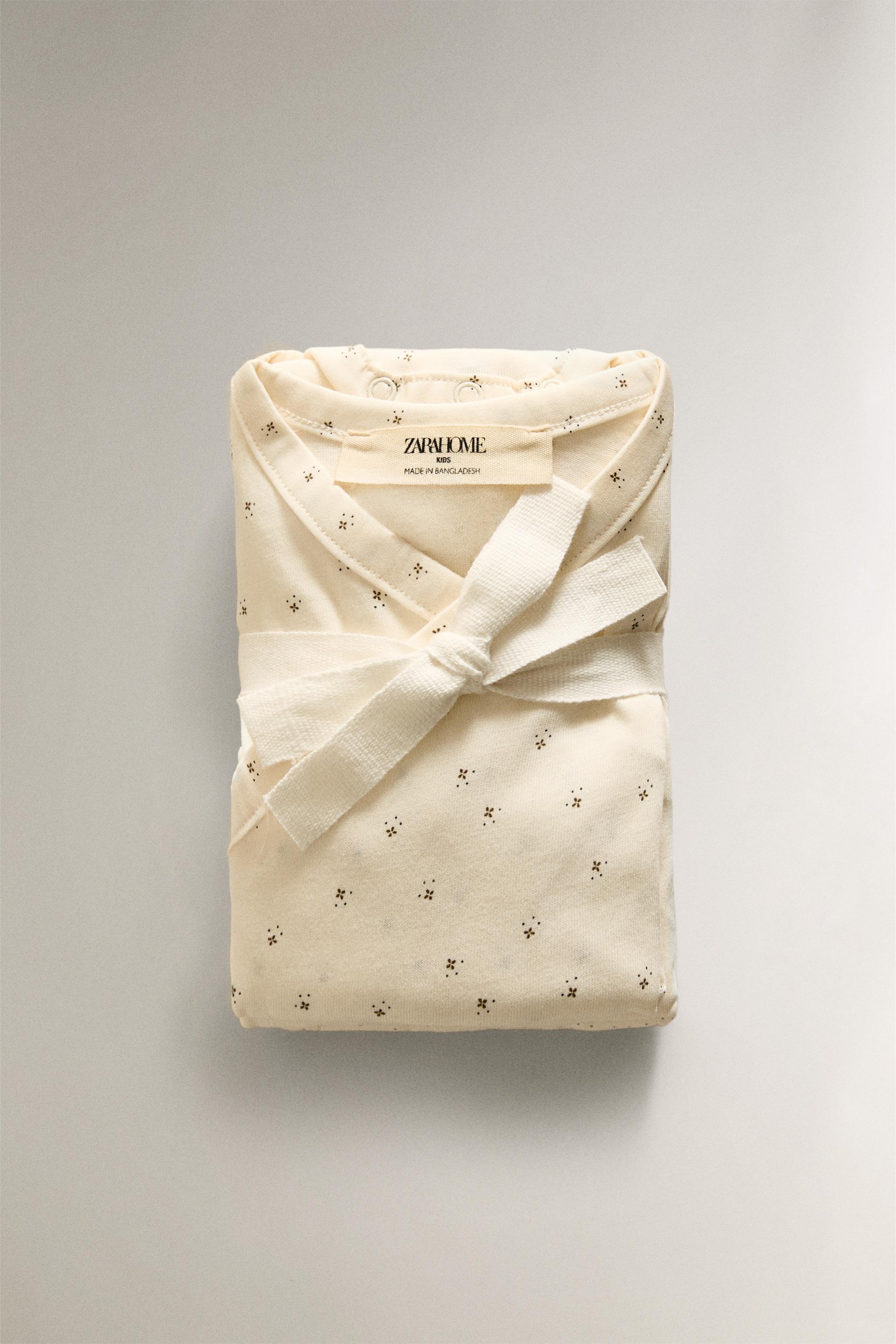 SET OF PRINTED BABY BODYSUITS